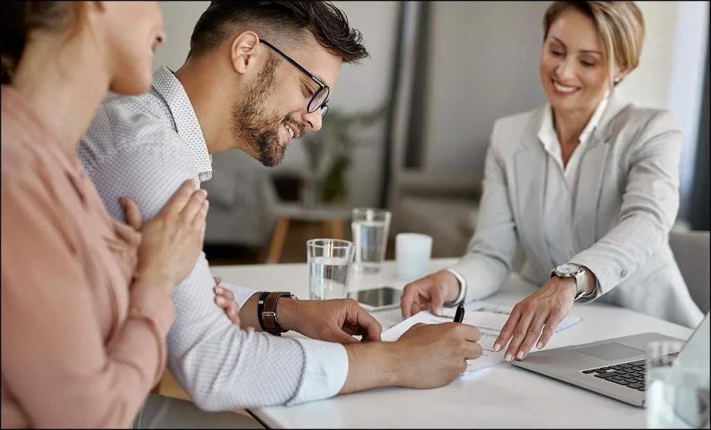 happy-man-his-wife-having-meeting-with-financial-advisor-signing-agreement-office (1).jpg